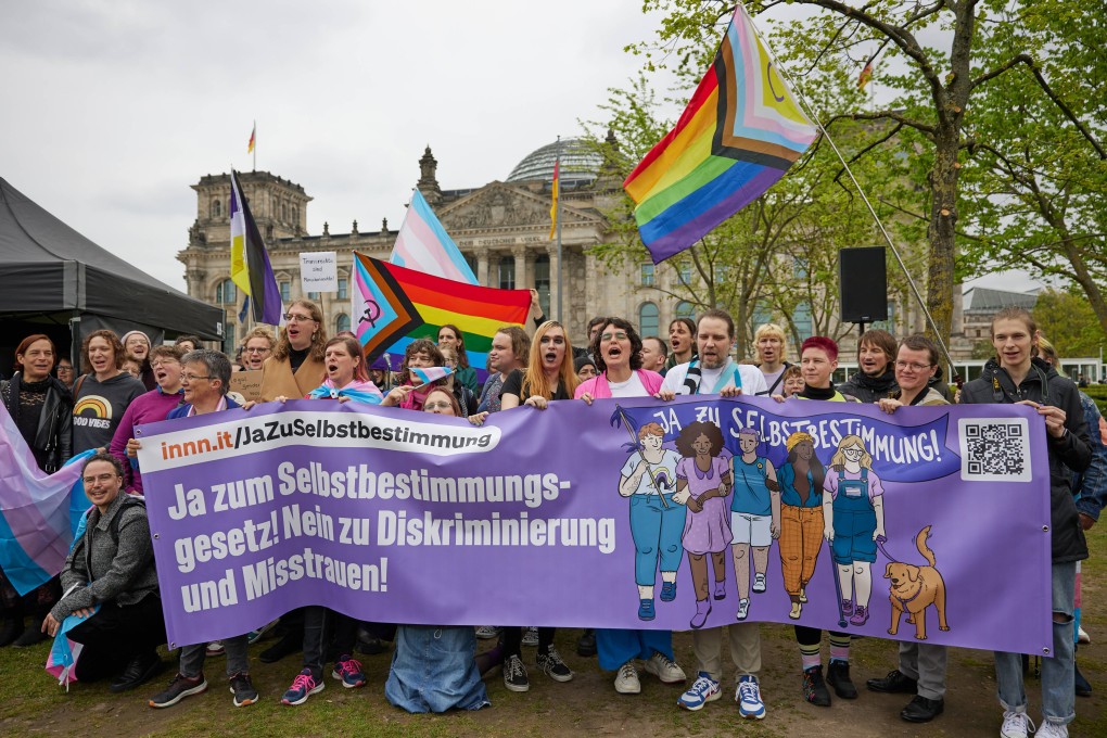 People hold a banner reading “Yes to the Self-Determination Act! No to discrimination and mistrust!” at a protest in front of Germany’s Bundestag. Photo: dpa