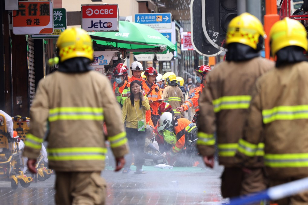 Firefighters and parademics outside New Lucky House at the junction of Jordan Road and Nathan Road on April 10. Photo: Jelly Tse