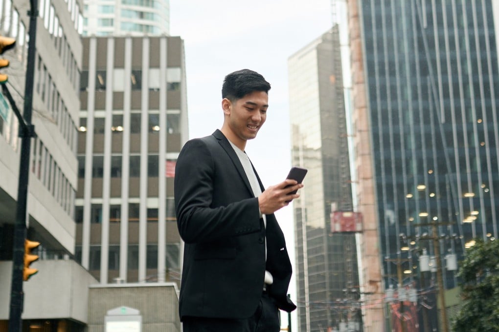 A Japanese business man investor stands amid downtown buildings. Numerous young Japanese workers are flocking to Australia in search of higher pay. Photo: Shutterstock