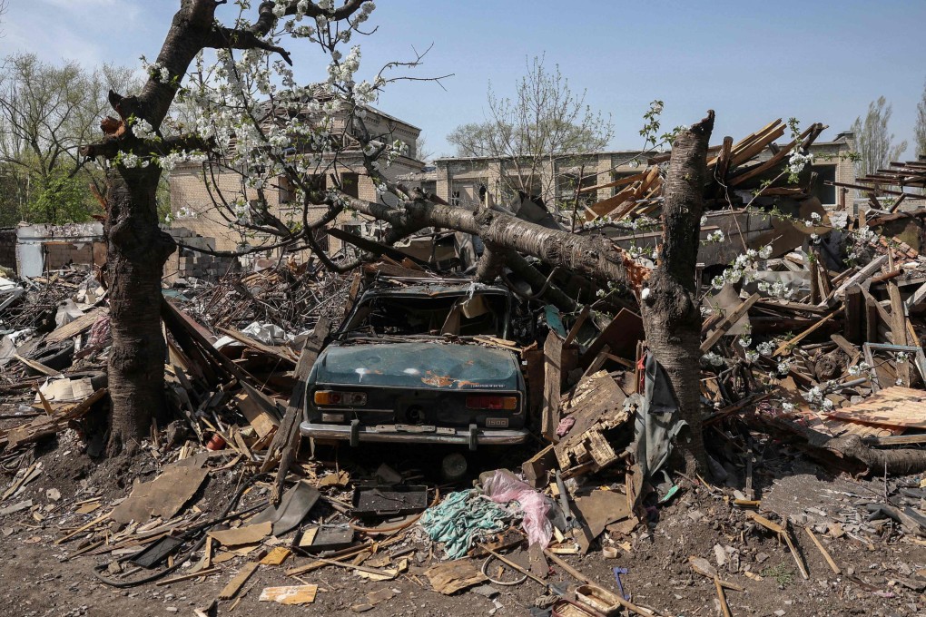 A destroyed car is seen in the yard of a house struck by missiles in the town of Selydove, in Ukraine’s Donetsk region, on Friday. Photo: AFP