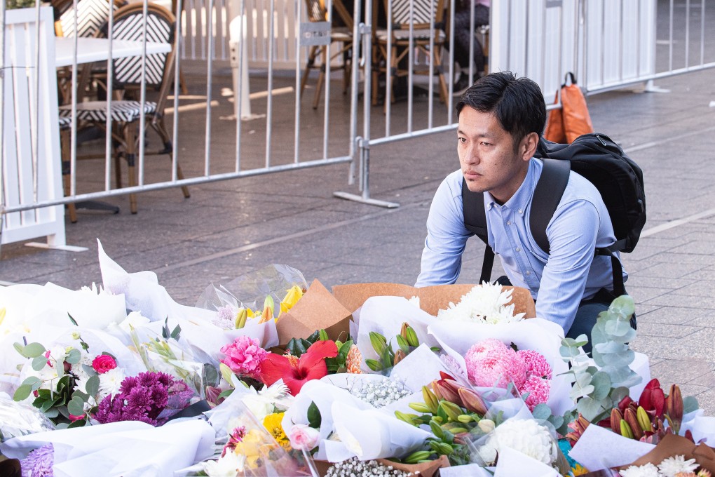A man reacts near a makeshift memorial outside the Westfield Bondi Junction shopping centre in tribute to the victims of a stabbing spree there on Saturday. Photo: EPA-EFE