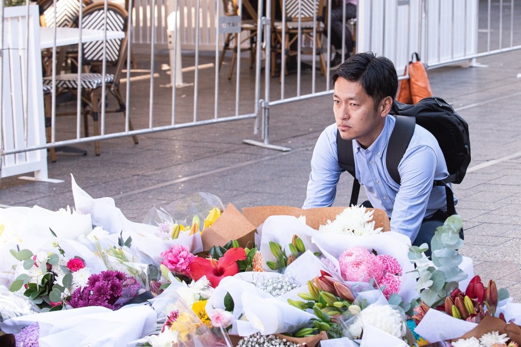 A man reacts near a makeshift memorial outside the Westfield Bondi Junction shopping centre in tribute to the victims of a stabbing spree there on Saturday. Photo: EPA-EFE