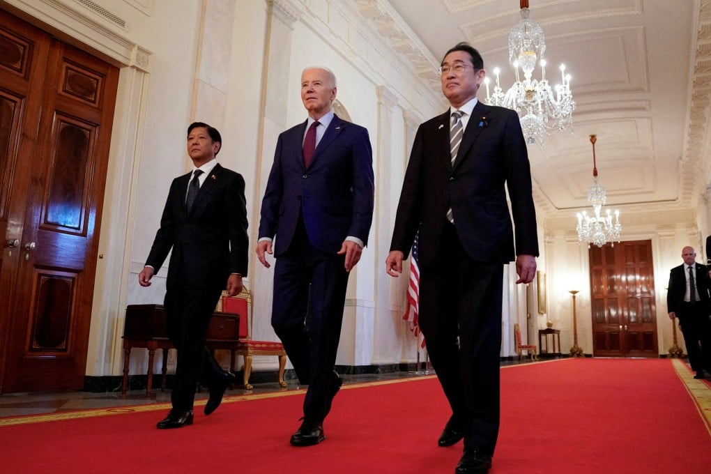 US President Joe Biden escorts Philippine President Ferdinand Marcos Jnr (left) and Japanese Prime Minister Fumio Kishida to their trilateral summit at the White House in Washington on April 11. Photo: Reuters