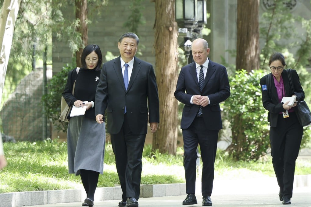 Xi Jinping and Olaf Scholz pictured strolling through the grounds of the Diaoyutai State Guesthouse in Beijing on Tuesday. Photo: Xinhua