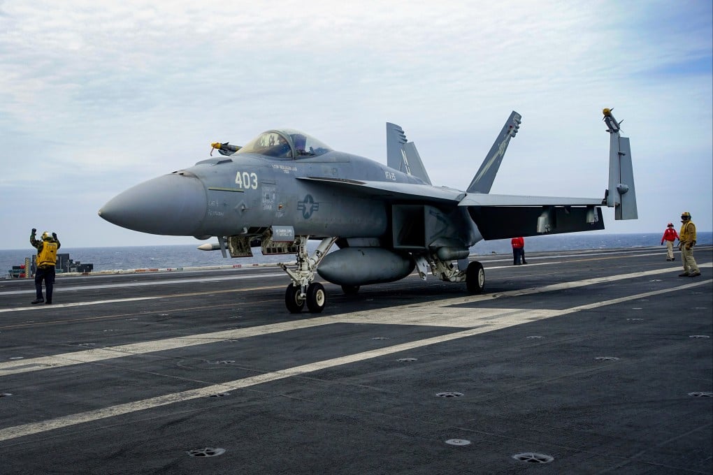 A US Navy F-18 waits on the flight deck of the USS Theodore Roosevelt aircraft carrier on Thursday during joint naval exercise with Japanese and South Korean forces in the East China Sea. Photo: AP