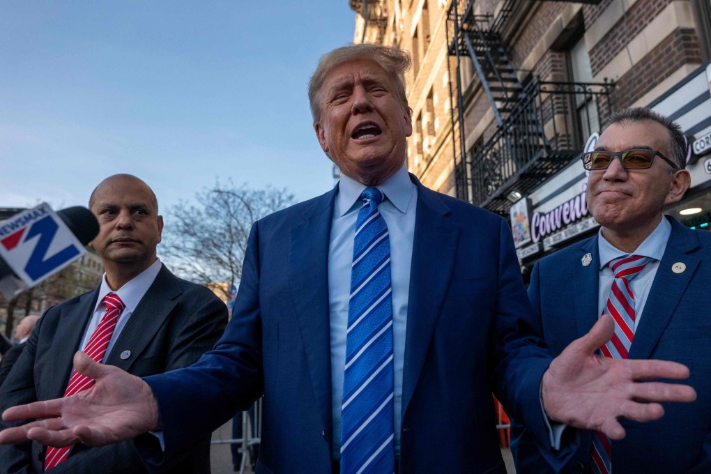 Donald Trump speaks to the media as he visits a bodega store in New York on Tuesday. Photo: AFP