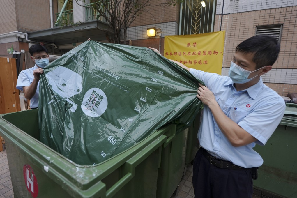 Property management officers display designated bags for waste disposal at On Ning House, Moon Lok Dai Ha, in Tseun Wan, on April 1 as part of a trial run. Photo: Eugene Lee