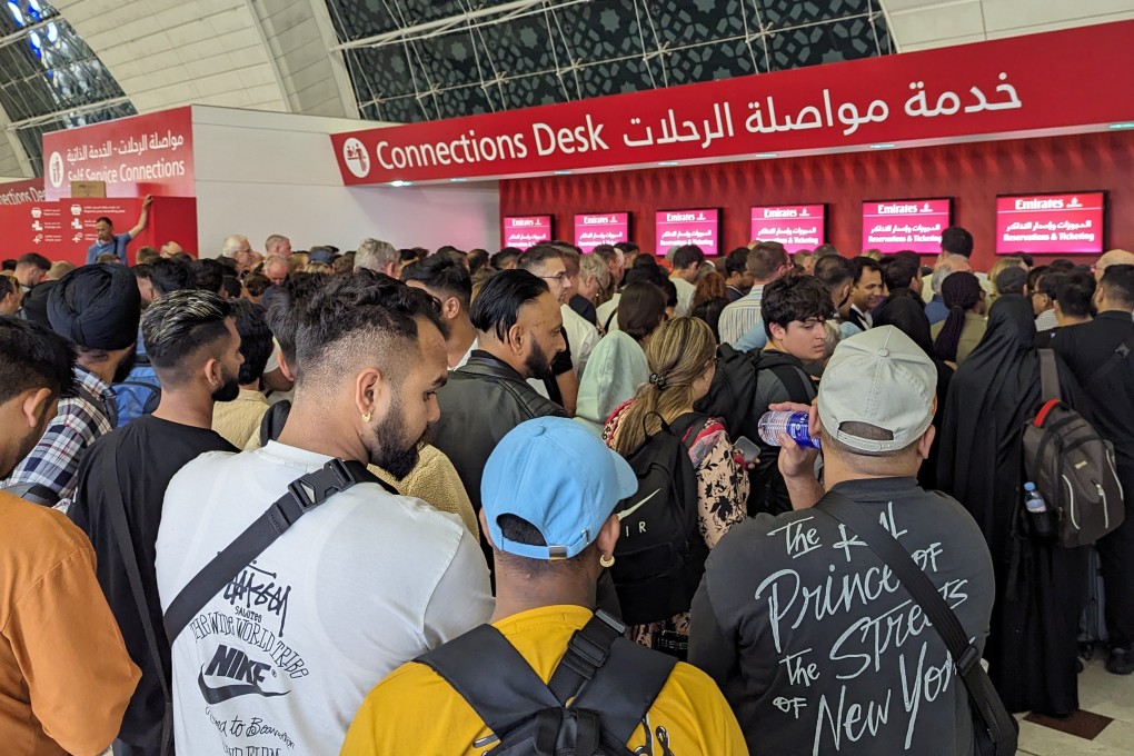 Stranded passengers search for information at Dubai International Airport on April 19, 2024, after more than 1,200 flights were cancelled following an unprecedented storm, leading to widespread travel chaos. Photo: Kevin Kwong