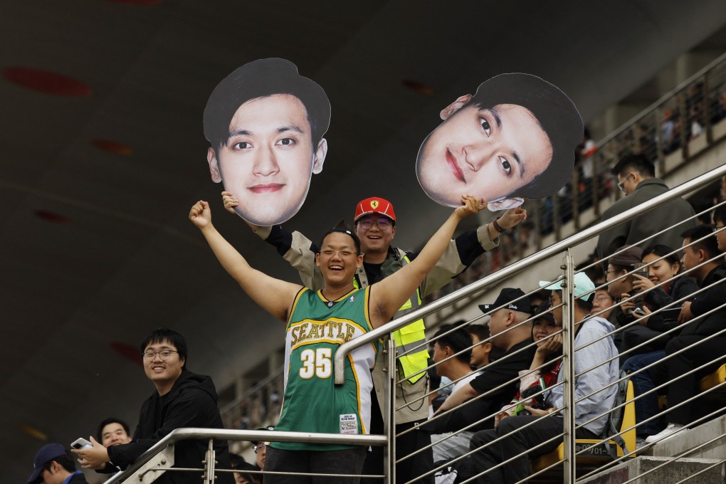 Fans in the stands hold up a cut-out of Sauber’s hometown hope Guanyu Zhou during the sprint qualifying session of the Chinese Grand Prix. Photo: Reuters