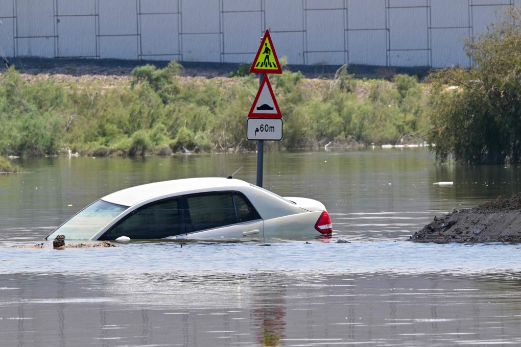 A car is stranded on a flooded street in Dubai following heavy rains on Thursday. Photo: AFP
