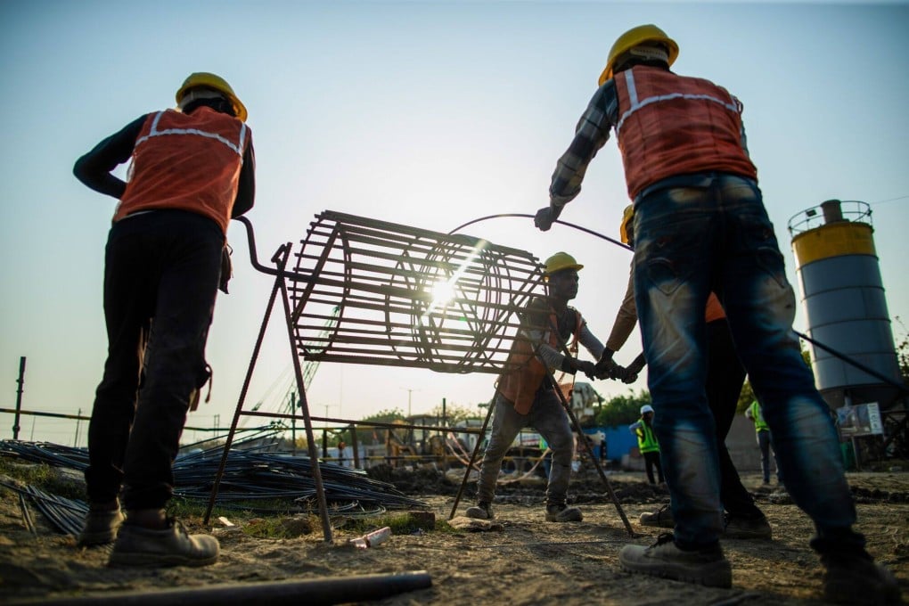 Labourers work on a construction site in Noida, a satellite city of New Delhi being built in Uttar Pradesh. To achieve developed-nation status, India’s turbocharged growth needs to lift all sectors of society. Photo: Bloomberg