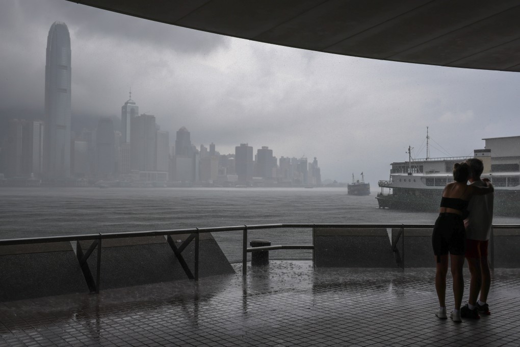 Pedestrians seek shelter from the rain in Tsim Sha Tsui. Photo: Jelly Tse