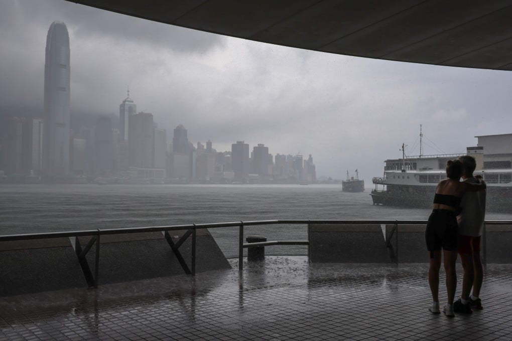 Pedestrians seek shelter from the rain in Tsim Sha Tsui. Photo: Jelly Tse