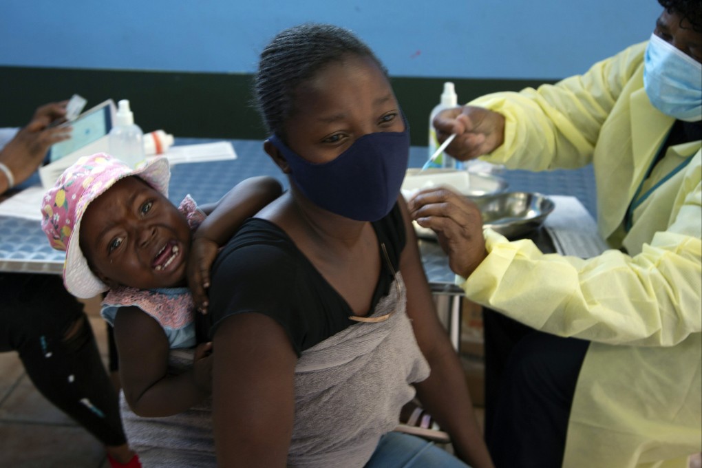 A baby cries as her mother receives a Covid-19 vaccine in a township near Johannesburg, South Africa, on October 21, 2021. Photo: AP