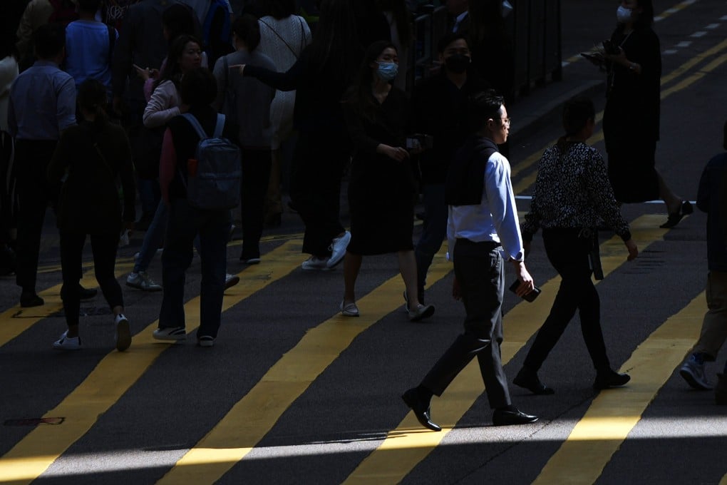 Pedestrians in Central. One expert has called for government incentives to help company transition to new ways of working. Photo: Eugene Lee