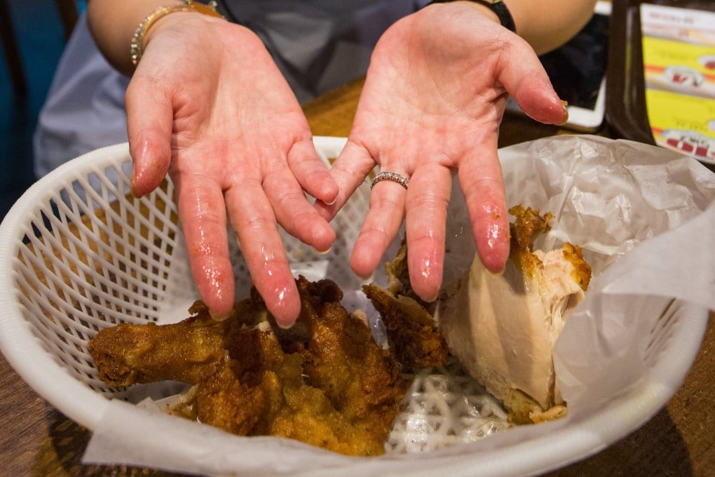 Some diners are unfazed by going glove-free to eat their chicken or have decided to come prepared with wet wipes. Photo: May Tse