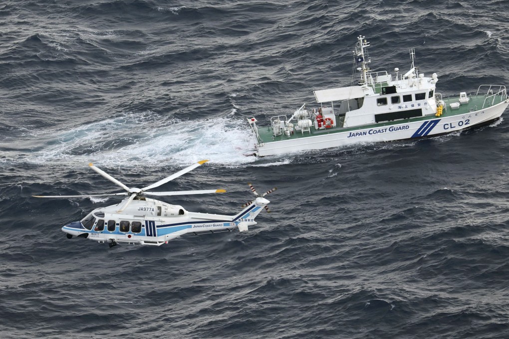 A Japan Coast Guard patrol ship and helicopter take part in a search and rescue mission in November. Photo: Kyodo