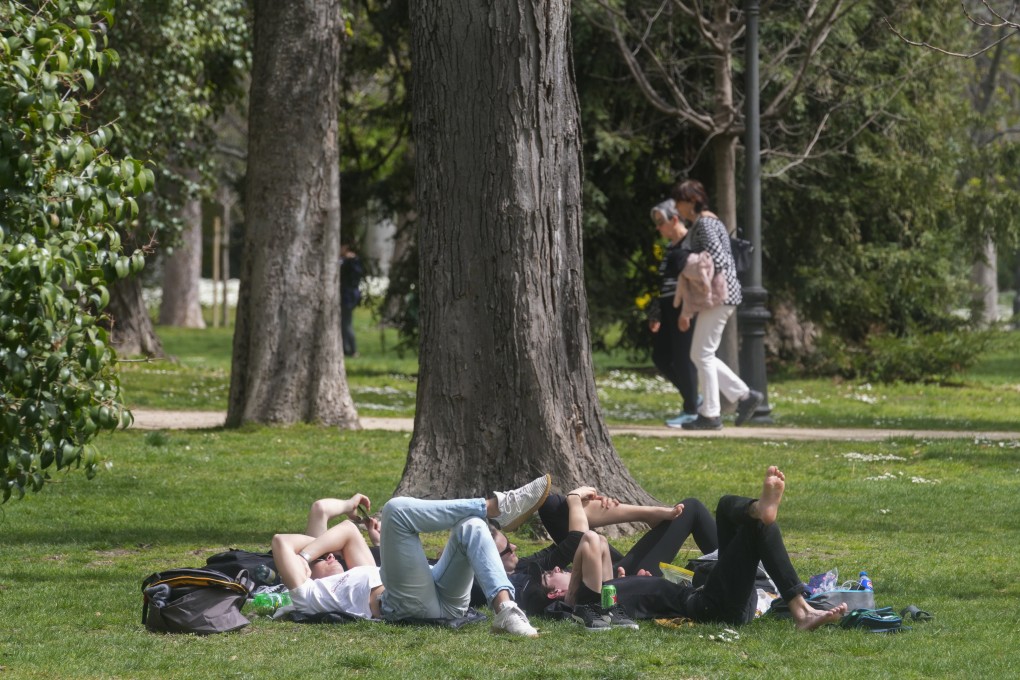 People relax in a park in Madrid, Spain, in March. Photo: AP