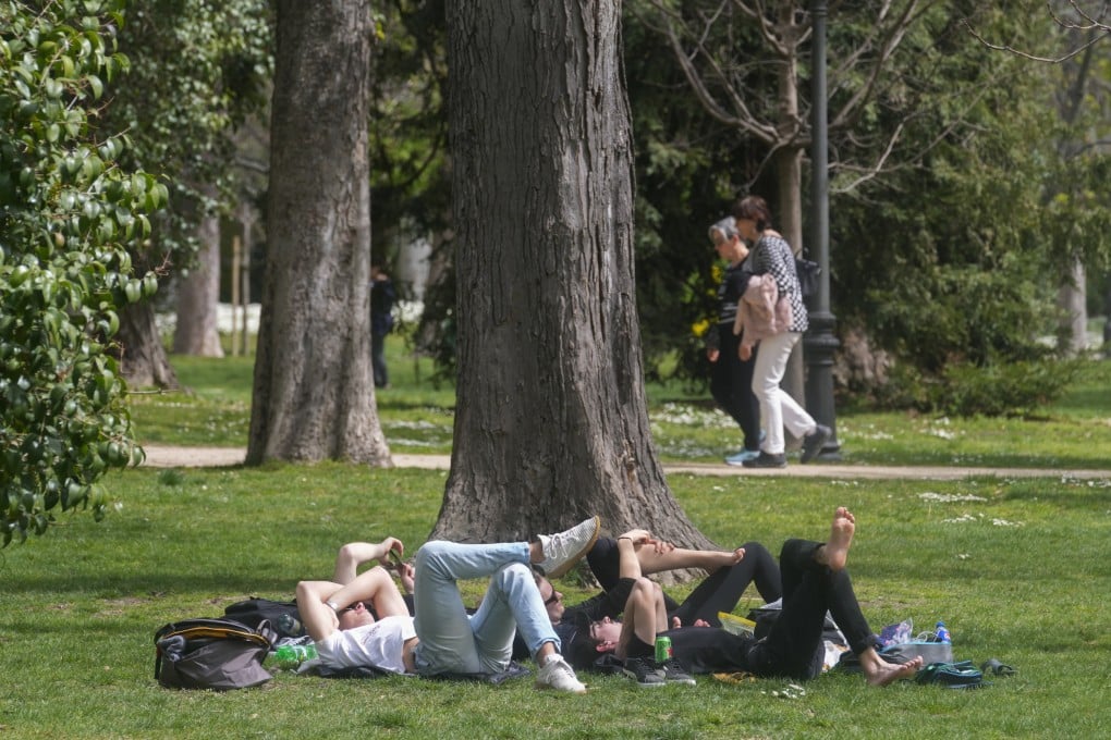 People relax in a park in Madrid, Spain, in March. Photo: AP