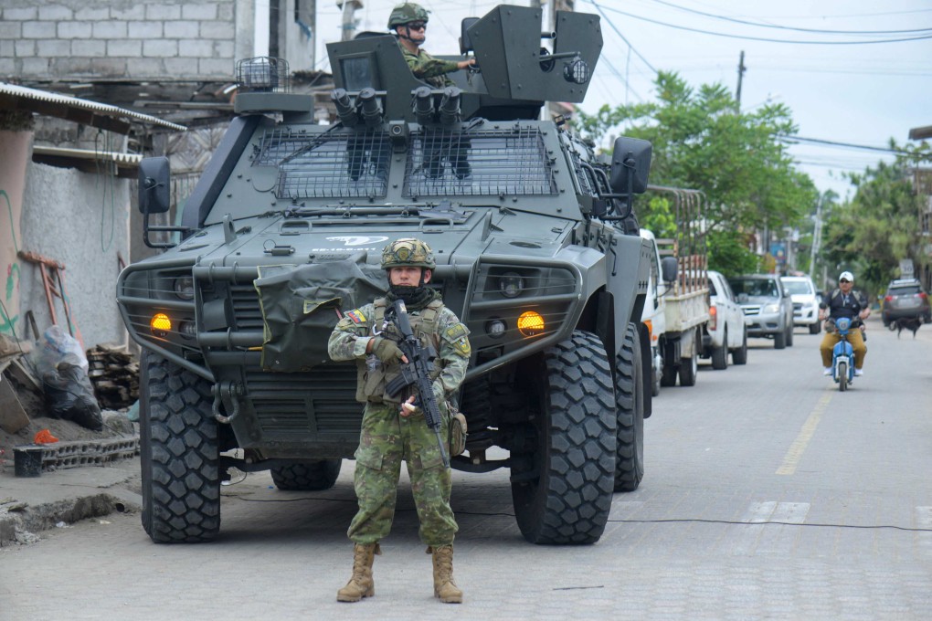 Soldiers stand guard outside a polling station during a referendum on tougher measures against organised crime in Olon, Santa Elena province, Ecuador on Sunday. Photo: AFP