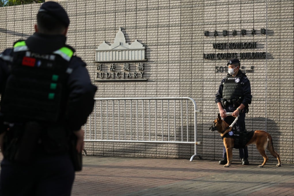 Police officers patrol outside West Kowloon Court amid Jimmy Lai’s ongoing national security trial. Photo: Xiaomei Chen