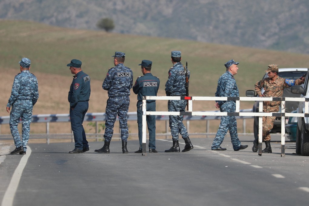 Armenian officers stand at a checkpoint leading to Azerbaijan’s Nagorno-Karabakh region. The neighbours have begun fixing their border, as part of normalisation efforts following a decades-long territorial conflict. Photo: Reuters