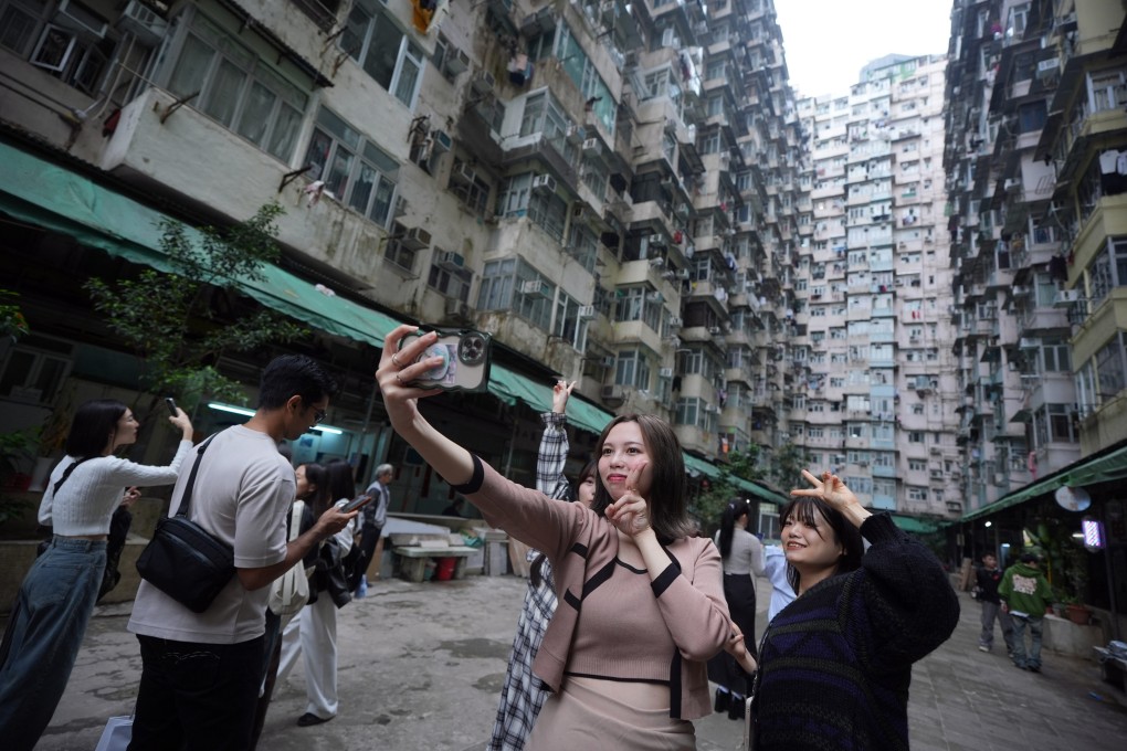 Tourists take pictures of the Instagram-famous Yick Cheong Building, popularly know as the ‘Monster Builidng’, in Quarry Bay. Photo: Eugene Lee