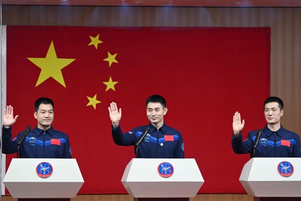Shenzhou-18 crew members (from left to right) Li Guangsu, Ye Guangfu and Li Cong wave during a press conference at the Jiuquan Satellite Launch Centre in northwest China on Wednesday. Photo: AFP