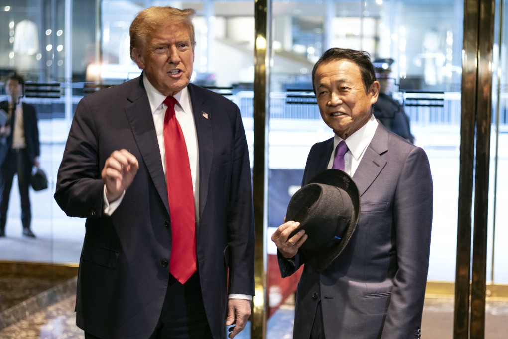 Donald Trump and former Japanese prime minister Taro Aso at Trump Tower in New York. Photo: AP