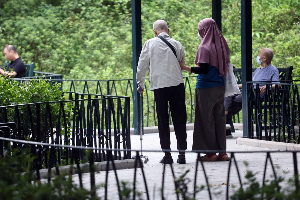A foreign domestic worker with an elderly man at a park in Jordan in October 2022. Photo: K.Y. Cheng