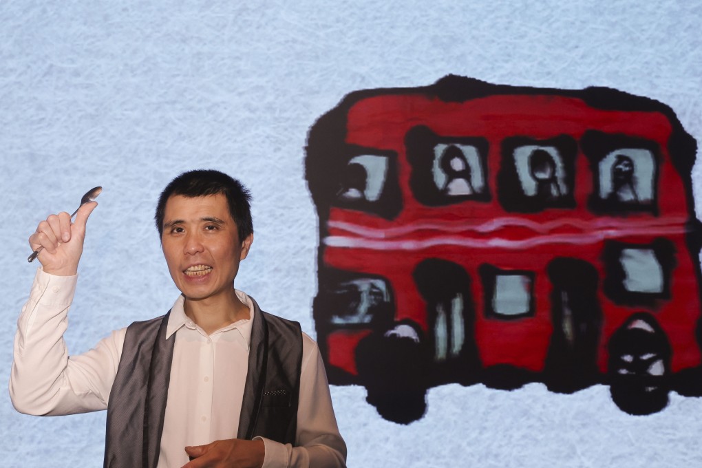 Wong Sai-kit holds a spoon, which he uses, along with paintbrushes, to create artworks such as the one behind him, on show with others at The Park Lane Hong Kong hotel in Hong Kong. Wong, 51, is intellectually disabled and on the autism spectrum. Photo: Edmond So