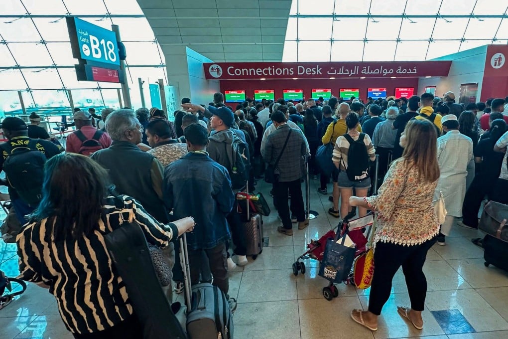 Passengers queue at a flight connection desk at Dubai International Airport on April 17, 2024. Flooding caused by record deluges in the United Arab Emirates led to the cancellation of more than 1,000 flights. Photo: AFP