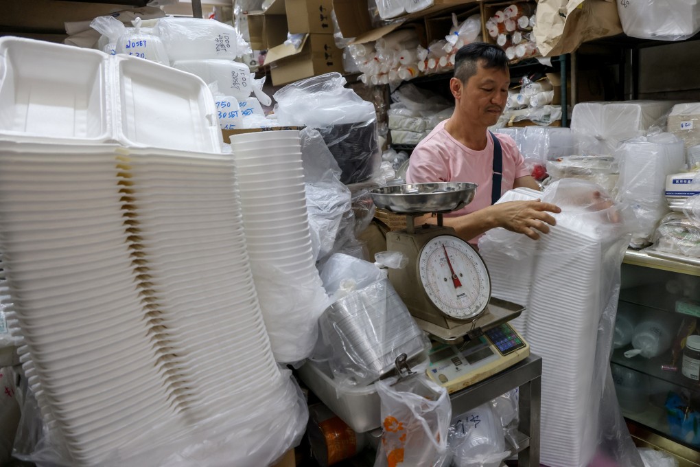 Dargon Cheung Kin-lung, owner of plastic tableware seller Luen Fat Plastic Bags in Sham Shui Po, handled his stock before a citywide ban on throwaway single-use plastics took effect. Photo: Dickson Lee