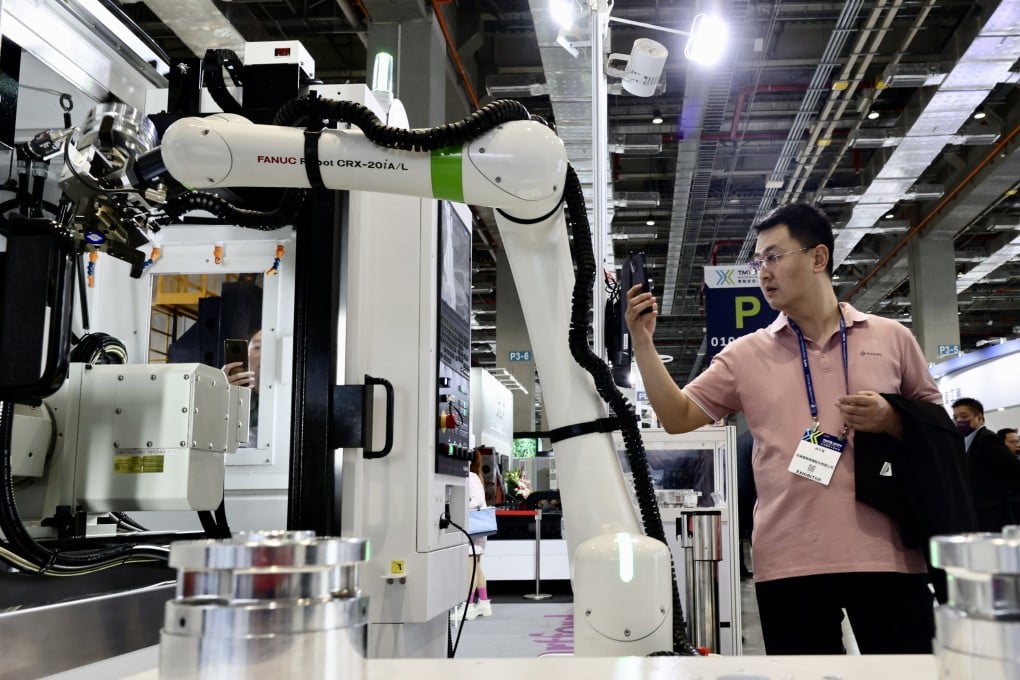 A visitor views a robotic arm in motion during the 2024 Taiwan International Machine Tool Show in Taipei in March. Photo: EPA-EFE