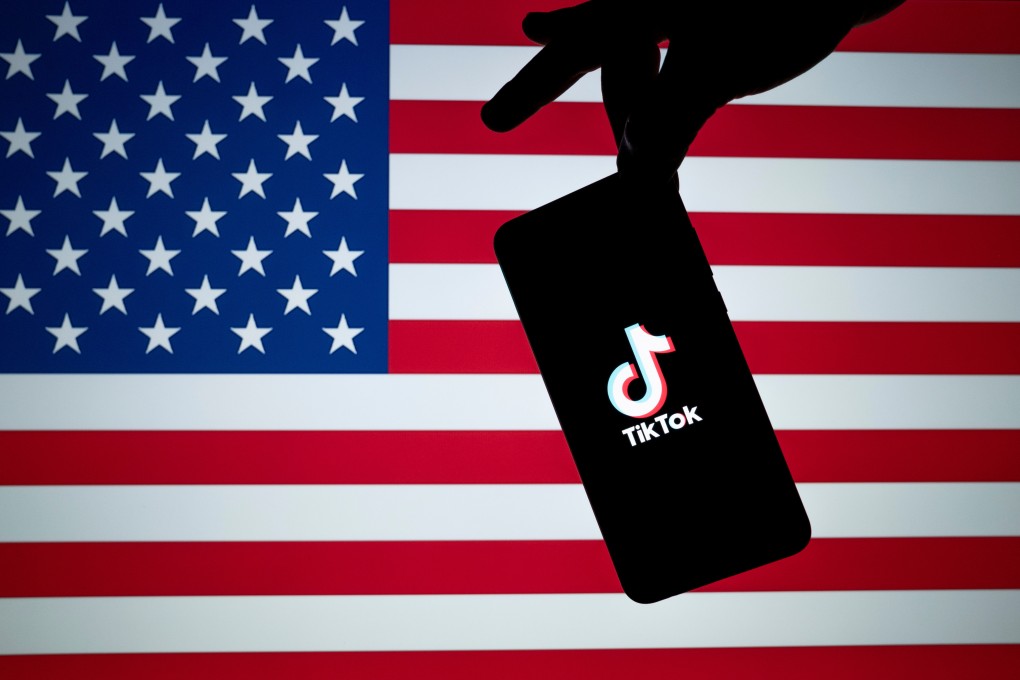 The TikTok logo is seen on the silhouette of a smartphone against an American flag. Photo: Shutterstock