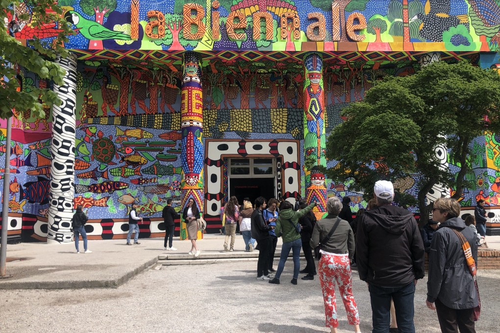 Visitors stand outside the entrance to the Central Pavilion of the Giardini section of the Venice Biennale, which for the 2024 edition houses part of the international exhibition titled “Foreigners Everywhere”. Photo: Enid Tsui