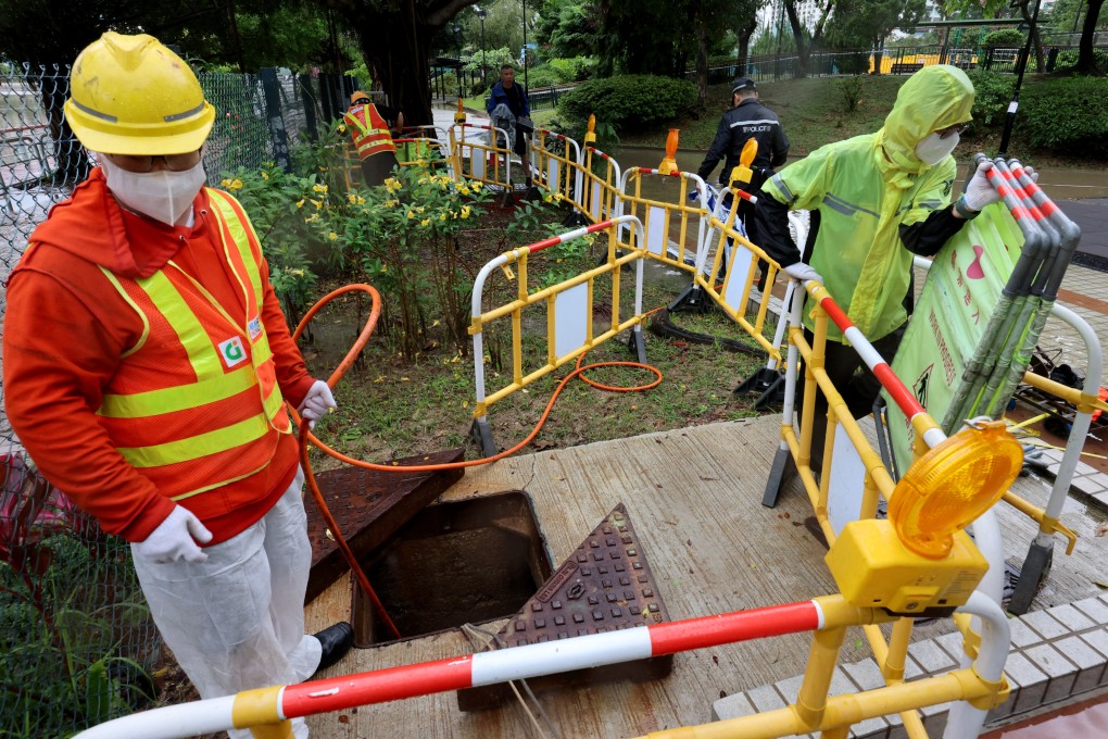 Police Crime Unit officers at Yuen Wo Playground in Sha Tin investigate the deaths of two drainage workers who were suspected to have inhaled methane gas while working there. Photo: Jelly Tse