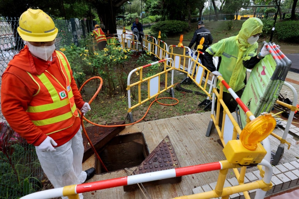 Police Crime Unit officers at Yuen Wo Playground in Sha Tin investigate the deaths of two drainage workers who were suspected to have inhaled methane gas while working there. Photo: Jelly Tse