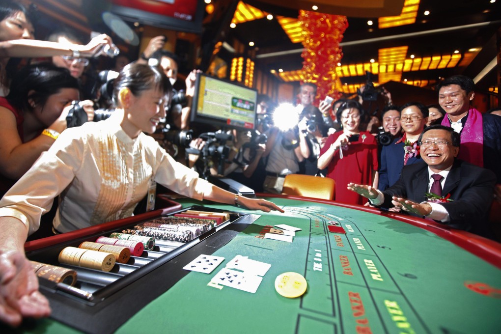 Chairman of Resorts World Sentosa and its developer, Malaysia’s Genting Group Lim Kok Thay plays baccarat to begin the soft opening of Singapore’s first casino in 2010. Photo: EPA-EFE