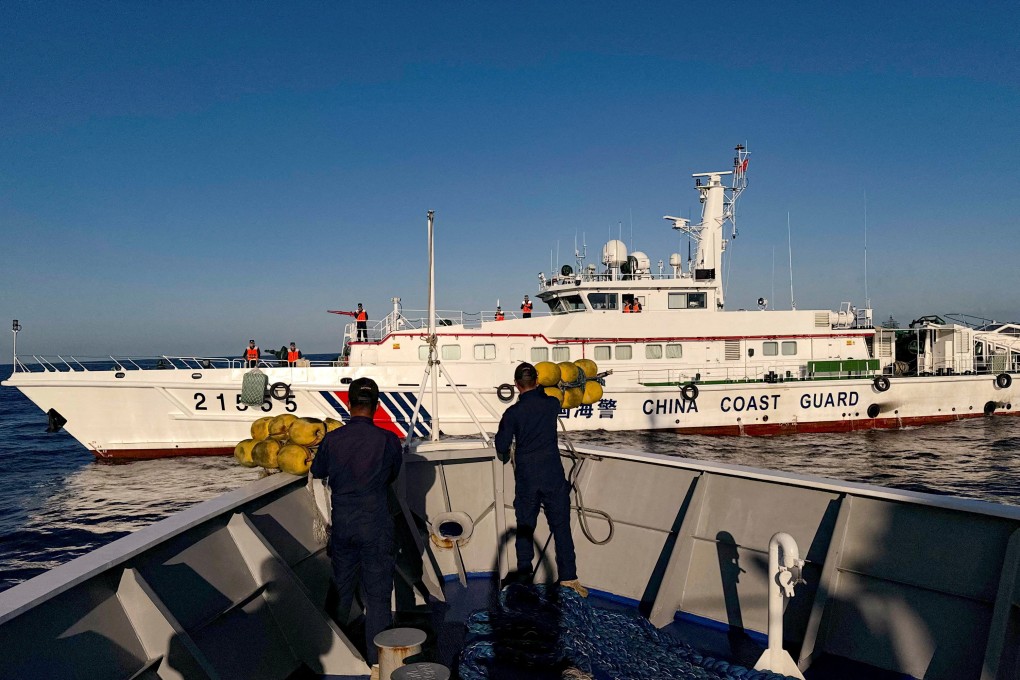 Philippine coastguard crew prepare rubber fenders as a Chinese vessel blocks their way to a resupply mission at the Second Thomas Shoal in March. Photo: Reuters