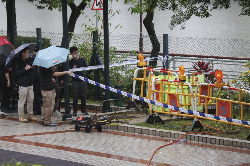 Police officers investigate the case of two  workers who were believed to have inhaled toxic gas in a manhole. Photo: Jelly Tse