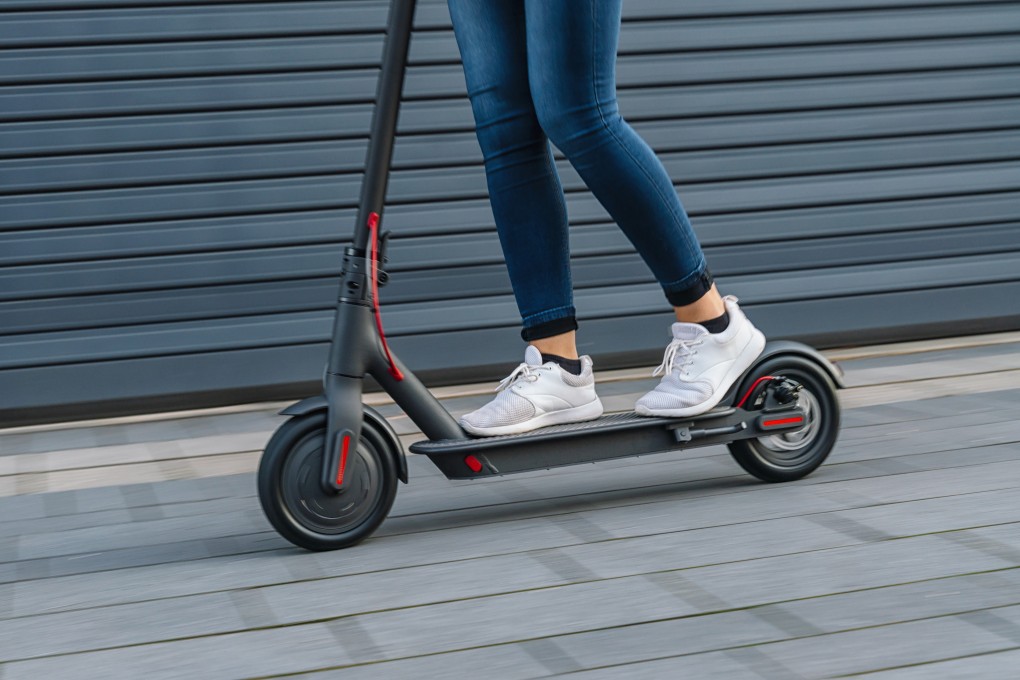 Close up of a woman riding an electric scooter. Photo: Shutterstock