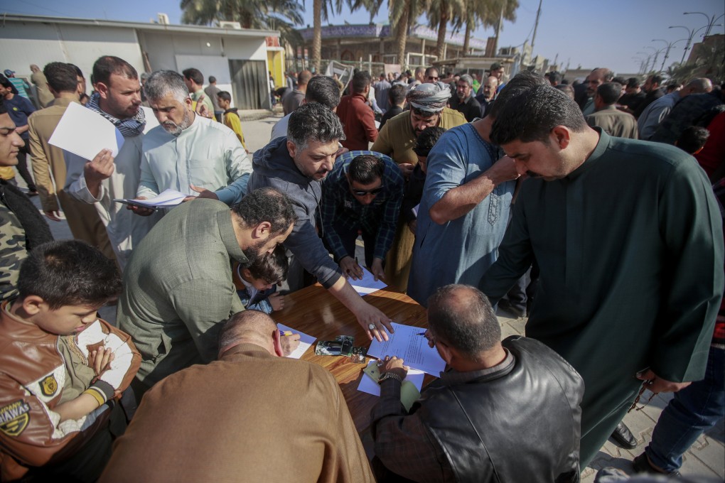 Iraqis sign a pledge to stand against homosexuality and LGBTQ people, outside a mosque in Kufa, Iraq. The country’s parliament on Saturday quietly passed a law that would impose heavy prison sentences on gay and transgender people. Photo: AP