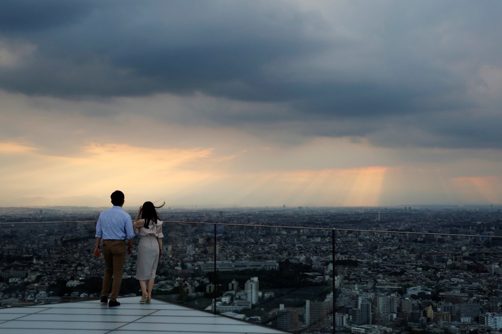 Visitors look out from Shibuya Sky, the observation deck atop Shibuya Scramble Square, in Tokyo, in June 2021. The falling yen has also added to the appeal of Japanese commercial property. Photo: Reuters