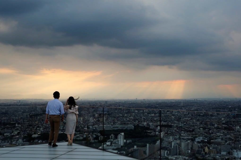 Visitors look out from Shibuya Sky, the observation deck atop Shibuya Scramble Square, in Tokyo, in June 2021. The falling yen has also added to the appeal of Japanese commercial property. Photo: Reuters