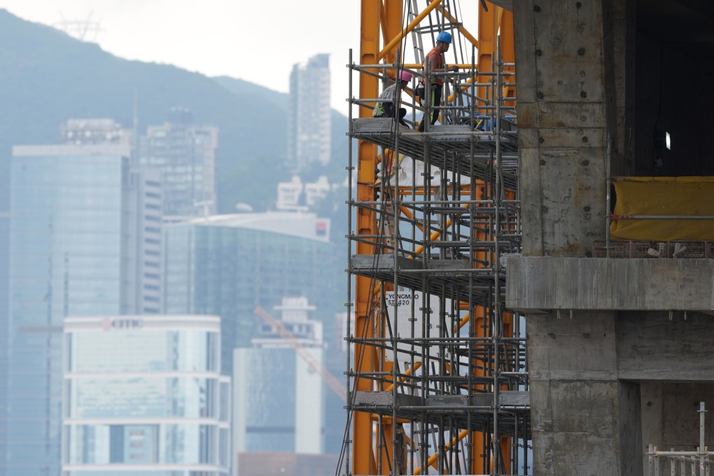 Construction workers are seen on scaffolding at a construction site in the West Kowloon Cultural District on April 27. The Hong Kong Construction Association has launched a trial scheme to monitor workers’ compliance with safety measures. Photo: Eugene Lee