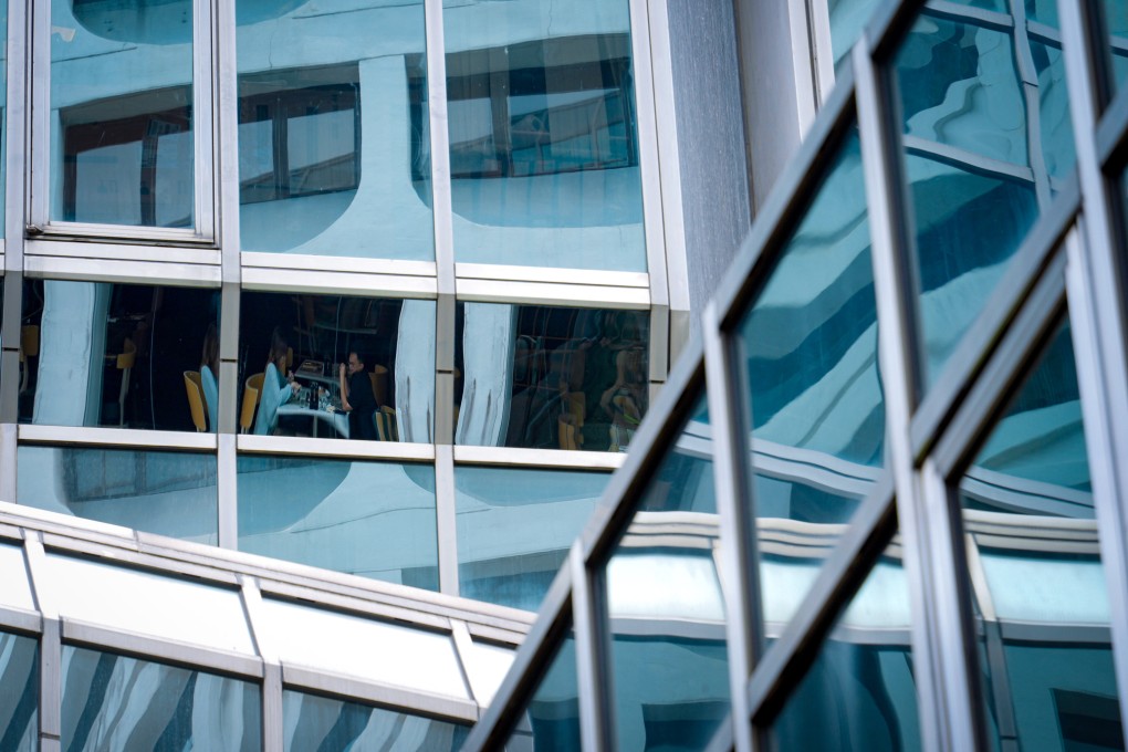 Diners are surrounded by geometric patterns of buildings on Canton Road in Hong Kong’s Tsim Sha Tsui district on April 17, 2024. Photo: Eugene Lee