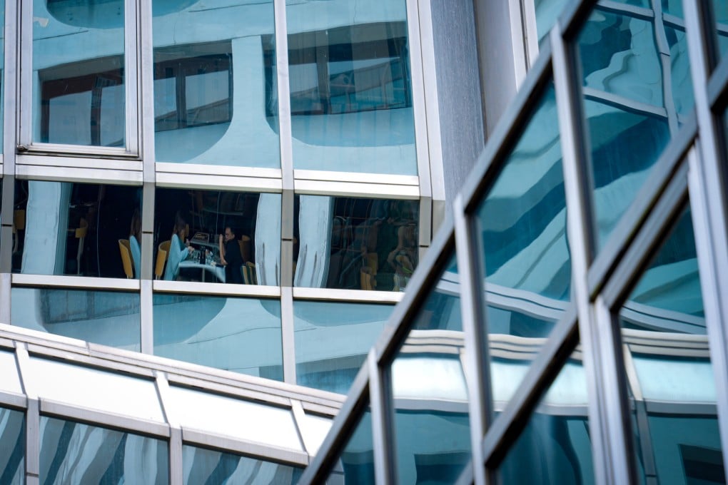 Diners are surrounded by geometric patterns of buildings on Canton Road in Hong Kong’s Tsim Sha Tsui district on April 17, 2024. Photo: Eugene Lee