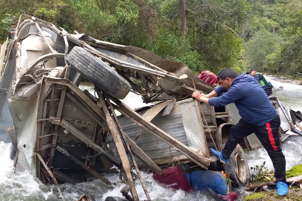 The remains of the bus that fell into a ravine, leaving at least 25 dead. Photo: Policia Nacional del Peru / AFP