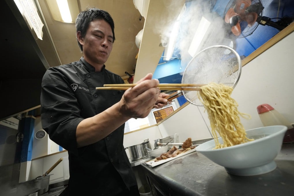 Kota Kobayashi prepares a bowl of ramen noodles. He runs a restaurant chain called Ore No Ikiru Michi in Tokyo. Photo: AP